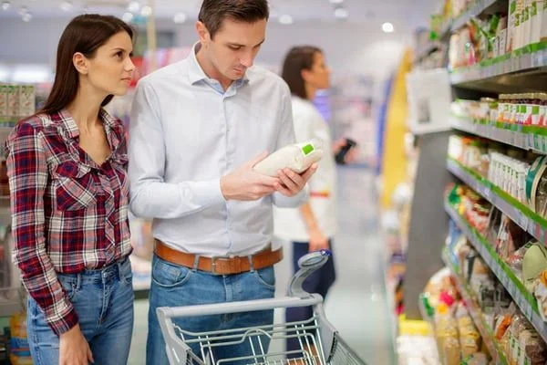 couple shopping in grocery store - JConnelly blog - Don’t Overlook the Power of a Clear Brand Voice 