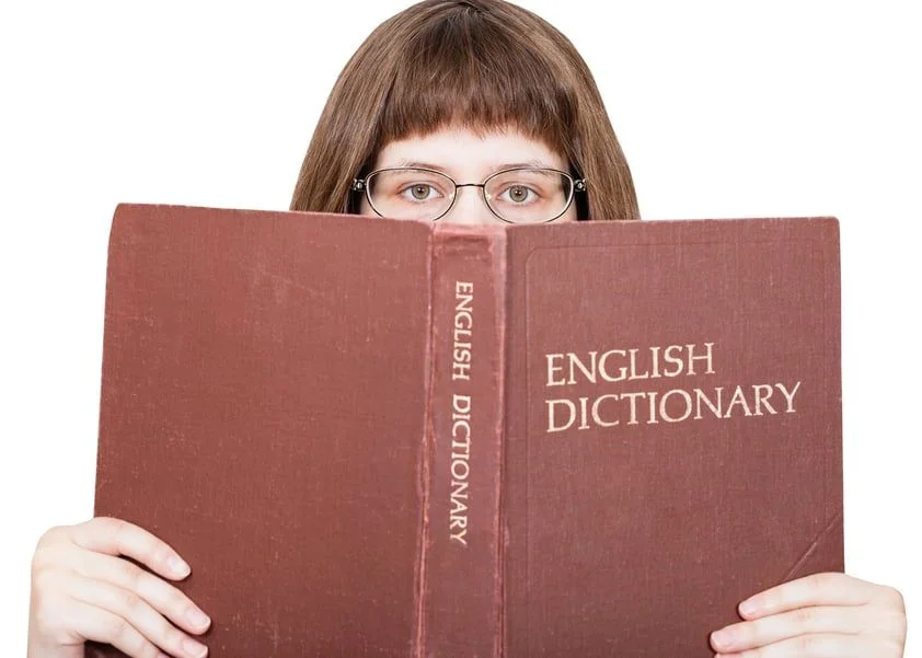 woman with dictionary- JConnelly blog- if the oxford dictionary can evolve we can too