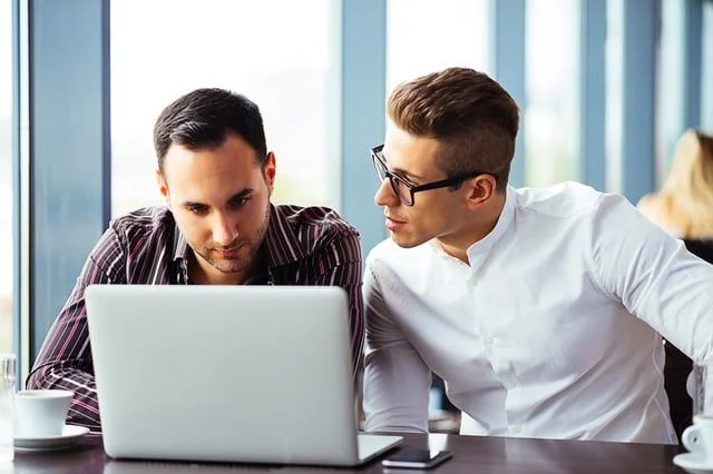 listen_to_what_your_customers_are_saying_and_build_a_plan_that_engages_them_on_social_media_-1.jpg 2 men on laptop- JConnelly blog- tips to master social media