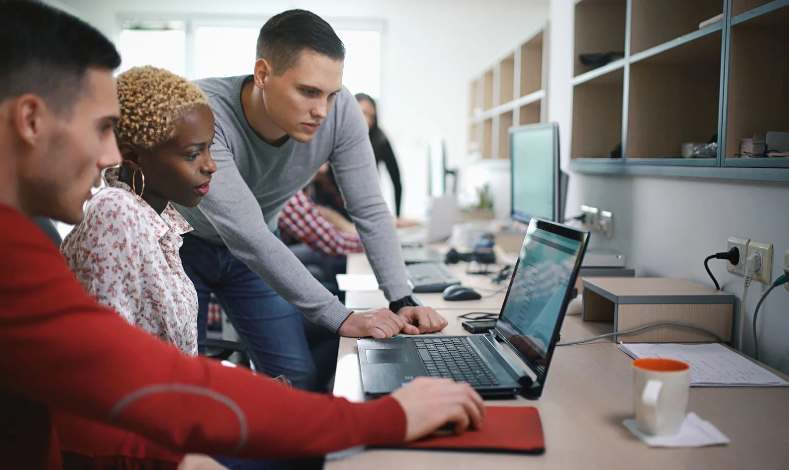 Team reviewing computer screen - JConnelly Blog - 8 Takeaways from Jack Dorsey's Talk on Cryptos, Diversity and the Mobile Workforce