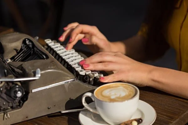 Woman typing on typewriter- JConnelly blog- Two Space, Or Not Two Space